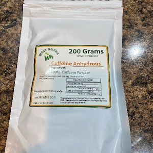 May include: A white resealable pouch of West Nutra Caffeine Anhydrous dietary supplement. The label displays 200 Grams, 100% Caffeine Powder, a supplement facts table, and the website westnutra.com. The text includes warnings not to exceed 400 mg daily.