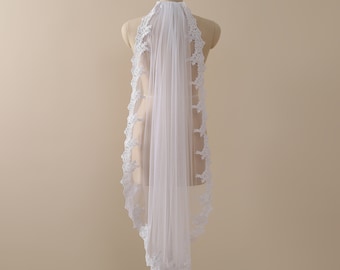 May include: A white bridal veil with a delicate lace trim. The veil is made of soft tulle and is designed to be worn over the head.