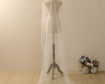May include: A long white bridal veil with a beaded edge. The veil is draped over a white dress form.