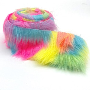 May include: A roll of rainbow colored faux fur trim with a glittery finish. The trim is made of soft, fluffy fibers and is perfect for adding a touch of whimsy to any project.