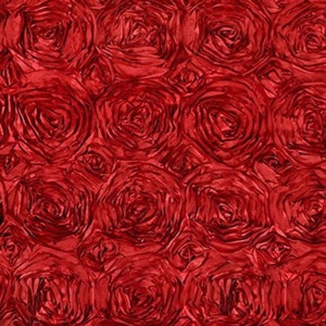 May include: Red satin fabric with a rosette pattern. The fabric is made of many small, overlapping rosettes that create a textured, three-dimensional effect.