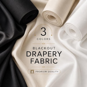 May include: Three rolls of blackout drapery fabric in black, beige, and white. The text on the fabric reads 3 COLORS BLACKOUT DRAPERY FABRIC PREMIUM QUALITY. The material has a smooth, matte texture and is arranged in flowing, draped folds.