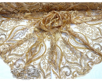 May include: Gold sequin lace fabric with a floral pattern. The fabric is sheer and has a delicate texture.  LA City Fabric is printed on the bottom of the image.