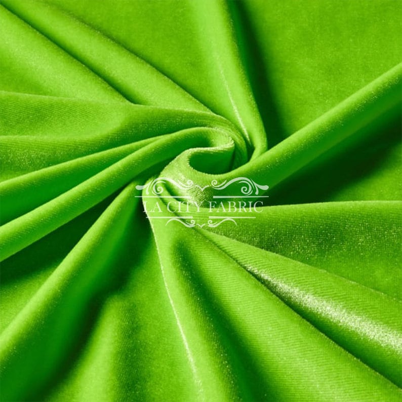 May include: A bright green velvet fabric with a subtle sheen. The fabric is folded and draped, showcasing its texture and color.