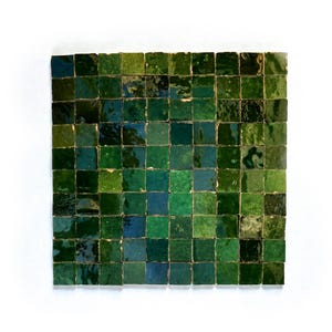 May include: A square of small, square tiles in shades of green and blue. The tiles have a glossy finish and vary in tone, creating a textured, mosaic-like appearance. The overall effect is a blend of cool and warm hues.