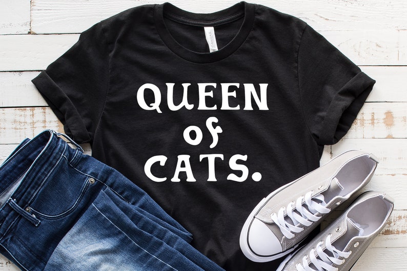 May include: Black t-shirt with white text that reads "QUEEN of CATS."