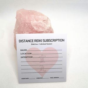 May include: A white card with the text "DISTANCE REIKI SUBSCRIPTION (Reiki box / Individual Session)" and a pink heart with Japanese characters. The card has fields for name, location, intention, start date, duration, and final session.