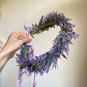 May include: A purple lavender flower crown with a pink ribbon tied around it.
