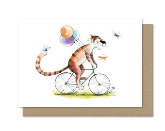 Handmade postcard on premium paper. Cute Tiger on a bike with balloons. Symbol of the new year 2022. Watercolor illustration. Original gift.