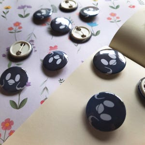 May include: A set of three ceramic mugs with a speckled, matte finish. The mugs are in shades of cream, light gray, and dark gray. Each mug has a simple, minimalist design, perfect for coffee or tea.