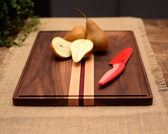 Dark Walnut cutting board with juice groove and decorative Maple stripes. Solid hard wood chopping block. Perfect foodie gift.