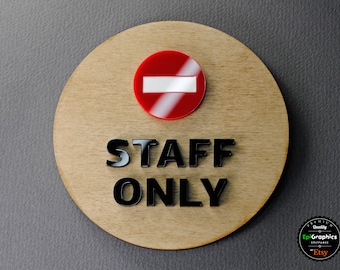 May include: A round wooden sign with the words "STAFF ONLY" in black letters. A red circle with a white bar across it is above the text.