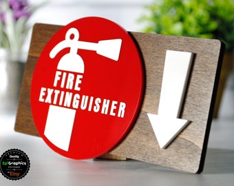 May include: A red and white wooden sign with the words "FIRE EXTINGUISHER" and a white arrow pointing down. The sign is on a brown wooden background.