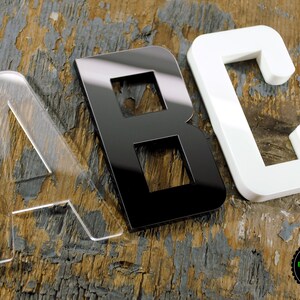 May include: Three acrylic letters, A, B, and C, in different colors. The letter A is clear, the letter B is black, and the letter C is white.