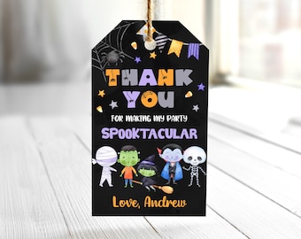 May include: Black Halloween gift tag with the words "THANK YOU" in orange and purple. The tag features illustrations of a mummy, Frankenstein, a witch, a vampire, and a skeleton. The text "FOR MAKING MY PARTY SPOOKTACULAR" is also included.