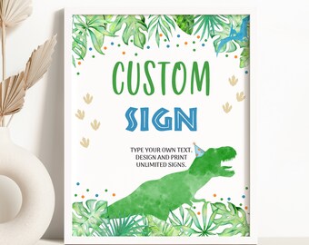 May include: A printable sign with a green dinosaur wearing a blue and white party hat. The sign says "CUSTOM SIGN" and "TYPE YOUR OWN TEXT, DESIGN AND PRINT UNLIMITED SIGNS". The background is green with tropical leaves and confetti.