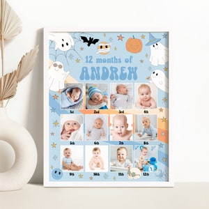以下が含まれることがあります： 「12ヶ月のANDREW」というテキストが入った、赤ちゃんの成長記録写真の額入りコラージュ。コラージュには、各月にラベル付けされた12枚の赤ちゃんの写真が掲載されています。デザインには、ハロウィーンをテーマにしたイラストと、青とオレンジの配色が含まれています。