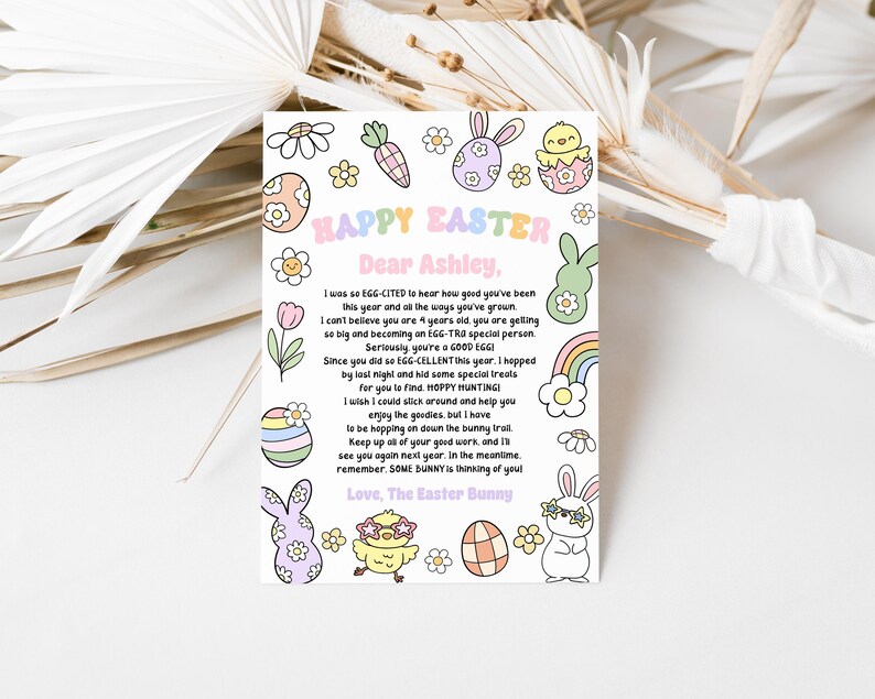 May include: A colourful card featuring a bunny rabbit and an Easter egg design. The card reads "Happy Easter" and "Dear Ashley". The text on the card says "I was so EGG-CITED to hear how good you've been this year and all the ways you've grown. I can't believe you are 4 years old. You are getting so big and becoming an EGG-TRA special person. Seriously, you're a GOOD EGG! Since you did so EGG-CELLENT this year, I hopped by last night and hid some special treats for you to find. HOPPY HUNTING! I wish I could stick around and help you enjoy the goodies, but I have to be hopping on down the bunny trail. Keep up all of your good work, and I'll see you again next year. In the meantime, remember, SOME BUNNY is thinking of you! Love, The Easter Bunny."