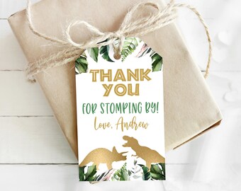May include: White thank you tag with green and gold dinosaur silhouettes and tropical leaves. The text reads "Thank You for Stomping By! Love, Andrew".