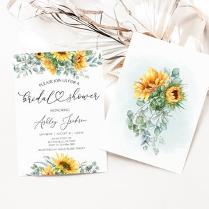 May include: A sunflower bridal shower invitation with a watercolor illustration of sunflowers and eucalyptus leaves. The invitation text reads "Please join us for a bridal shower honoring Ashley Jackson. Saturday, August 10, 2:00 PM, GTINESTATE OR, BLYTHEVILLE, AR 72316. RSVP to 123-456-7890. Registered at Amazon and Target."