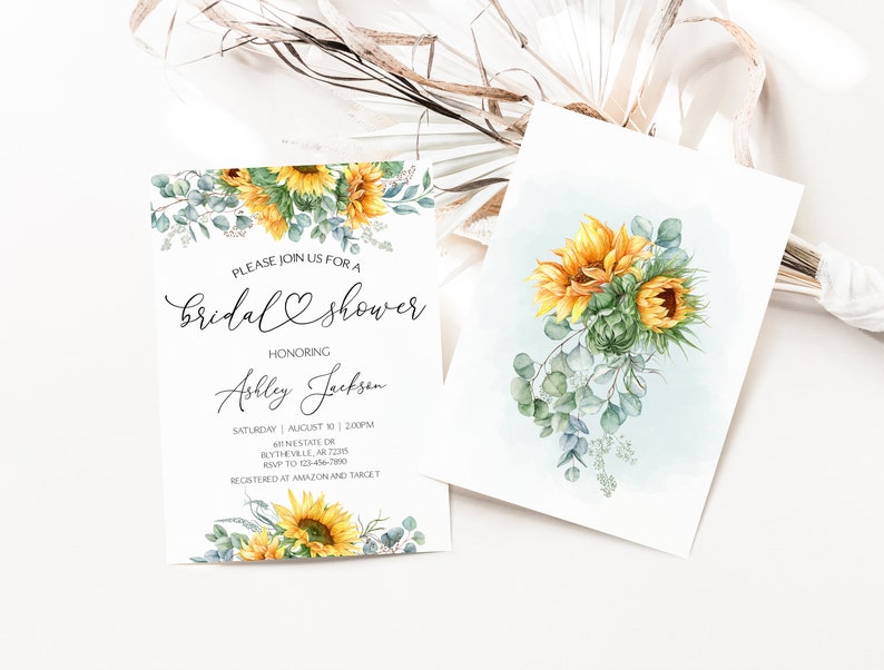 May include: A sunflower bridal shower invitation with a watercolor illustration of sunflowers and eucalyptus leaves. The invitation text reads "Please join us for a bridal shower honoring Ashley Jackson. Saturday, August 10, 2:00 PM, GTINESTATE OR, BLYTHEVILLE, AR 72316. RSVP to 123-456-7890. Registered at Amazon and Target."