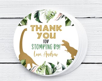 May include: Round thank you sticker with a green and gold dinosaur design. The sticker says "Thank You for Stomping By! Love, Andrew".
