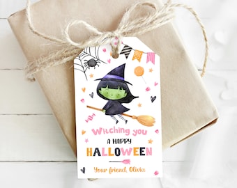 May include: A gift tag with a watercolor illustration of a green-skinned witch flying on a broomstick. The tag reads "Witching you a Happy Halloween" with the name "Olivia" at the bottom. The tag is tied to a wrapped gift with twine.