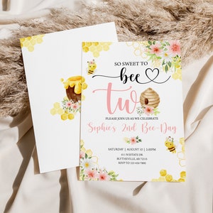 May include: A pink and yellow invitation card with a beehive and bees. The text reads "So sweet to bee two. Please join us as we celebrate Sophie's 2nd Bee-Day. Saturday, August 10, 2:00PM, 611 N Estate Dr, Blytheville, AR 72315, RSVP to 123-456-7890."