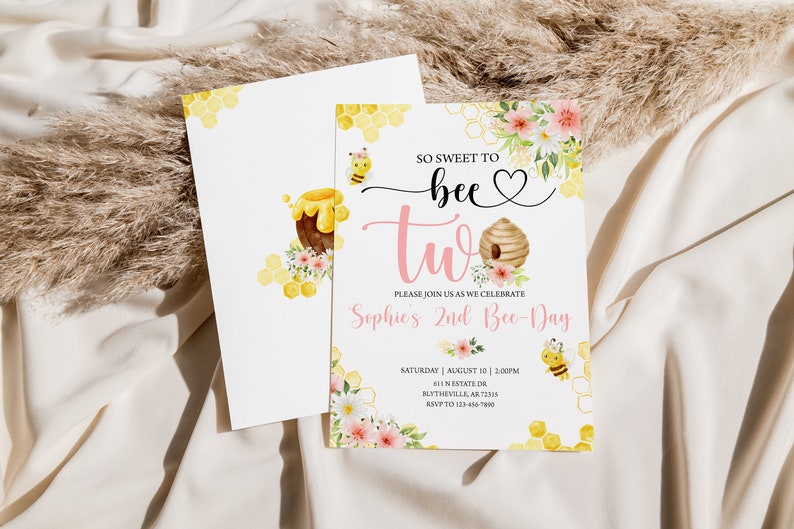 May include: A pink and yellow invitation card with a beehive and bees. The text reads "So sweet to bee two. Please join us as we celebrate Sophie's 2nd Bee-Day. Saturday, August 10, 2:00PM, 611 N Estate Dr, Blytheville, AR 72315, RSVP to 123-456-7890."