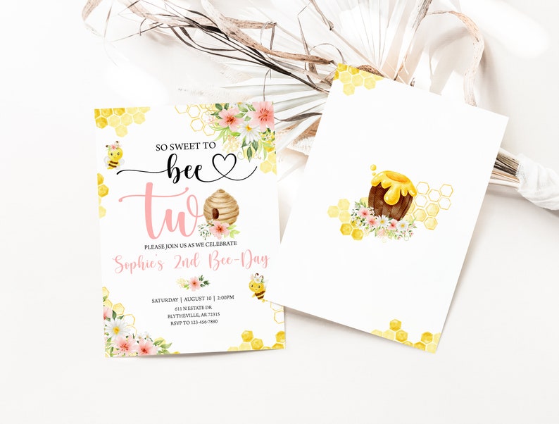 May include: A pink and yellow bee-themed invitation for a second birthday party. The invitation features a bee, a honeycomb, a beehive, and flowers. The text on the invitation reads "So sweet to bee two. Please join us as we celebrate Sophie's 2nd Bee-Day. Saturday, August 10 | 2:00PM. 501 N. Estate Dr. Blytheville, AR 72315. RSVP to 123-456-7890."