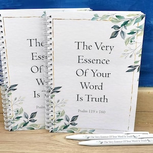 May include: Two white spiral bound notebooks with gold accents and green leafy designs. The text on the notebooks reads "The Very Essence Of Your Word Is Truth" and "Psalm 119 v 160".
