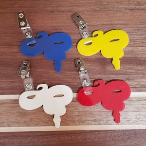 May include: Four colorful snake-shaped lanyards with clear plastic badge holders. The lanyards are blue, yellow, white, and red.