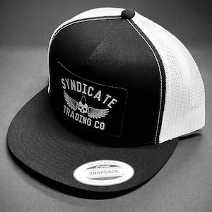 Syndicate Trading Co Winged Skull Patch Flat Bill Trucker Hats In Multiple Colors