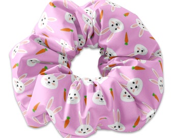 May include: Pink scrunchie with a repeating pattern of white bunnies and orange carrots.