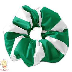 May include: Green and white striped scrunchie. The scrunchie is made of fabric and is in the shape of a circle.