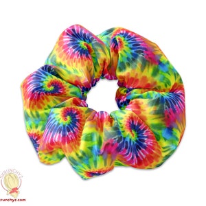 May include: A colorful tie-dye scrunchie with a swirl pattern in shades of yellow, blue, pink, and green.