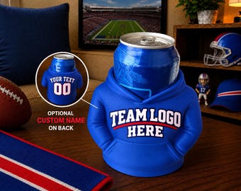 May include: A blue foam beverage insulator shaped like a miniature hoodie, holding a blue aluminum can. The front features the white text "TEAM LOGO HERE" in a bold font. A circular inset shows the back with the white text "YOUR TEXT" and "00".