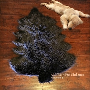 May include: A black faux fur tree rug on a wood floor. The rug is shaped like a Christmas tree. The text "All I Want Fur Christmas" and "Fur Accents ©" is visible in the bottom right corner of the image.