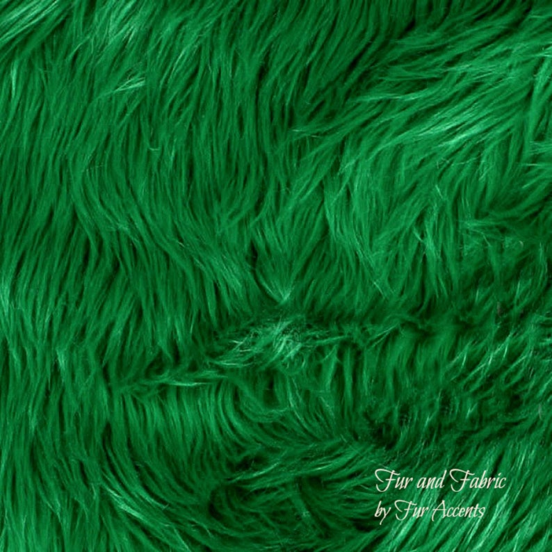 May include: A close-up of a plush, green faux fur fabric. The fabric has a soft, fluffy texture and is perfect for crafting projects, home decor, and more.