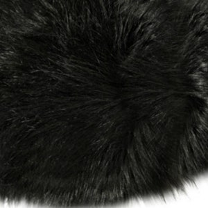 May include: Black faux fur rug with a soft, fluffy texture.