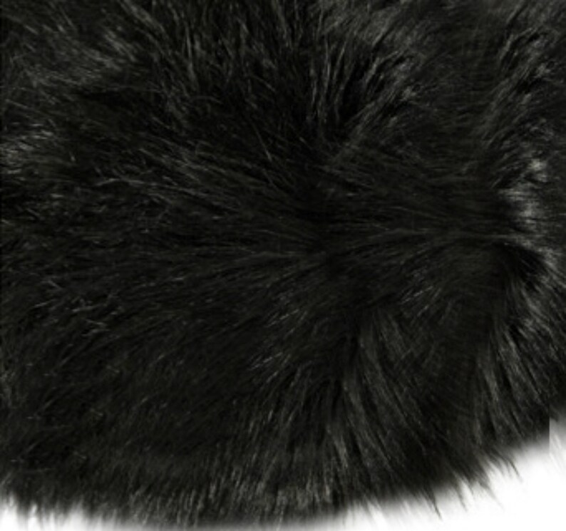 May include: Black faux fur rug with a soft, fluffy texture.