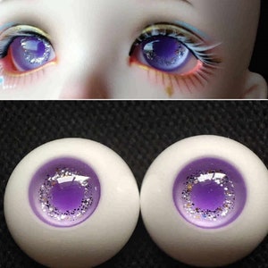 May include: Two purple and silver doll eyes with a white iris and a sparkly purple pupil.