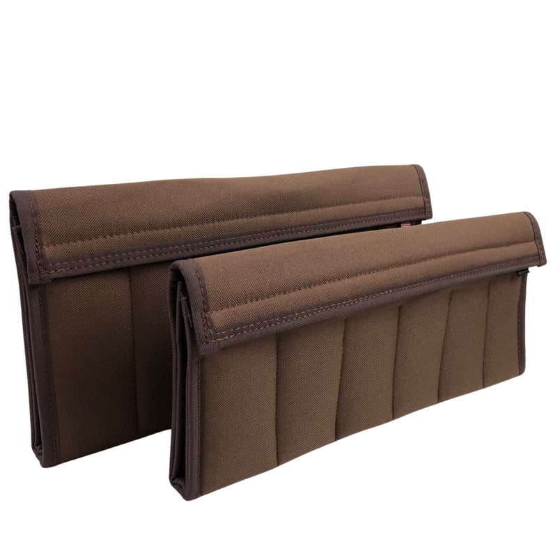 May include: Two brown fabric organizers with a quilted design. The organizers are rectangular with a flap closure and are in different sizes. The edges are trimmed with a darker brown fabric.