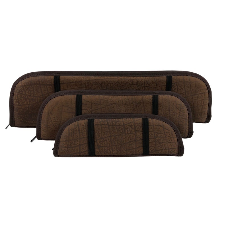 May include: Four brown cases of varying sizes, arranged in a stacked formation. Each case features a textured surface, a dark brown trim, and a black elastic band. The cases have a curved, semi-circular shape.