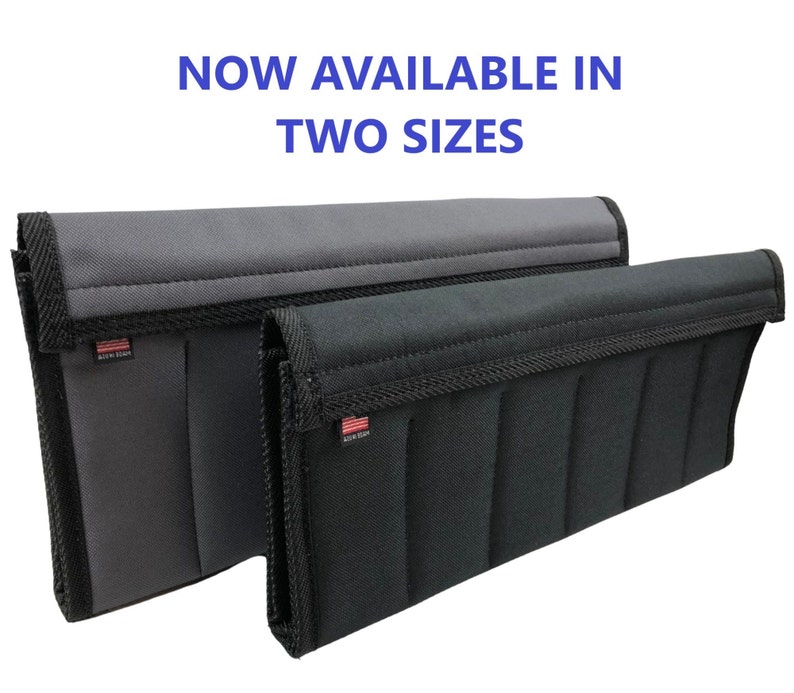 May include: Two rectangular, padded storage organizers in gray and black, with black trim and stitching. The text "NOW AVAILABLE IN TWO SIZES" is displayed in blue at the top. Each organizer has a small American flag label.