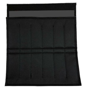 May include: Black knife roll with multiple slots for storage. The roll is made of a durable fabric and features a Velcro closure. The interior has several vertical stitched dividers to separate the knives.