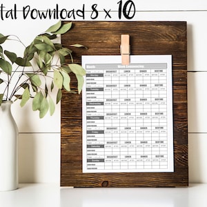May include: Printable weekly meal planner with a gray and white design. The planner includes sections for breakfast, lunch, dinner, and bedtime. The planner is labeled "Week Commencing".