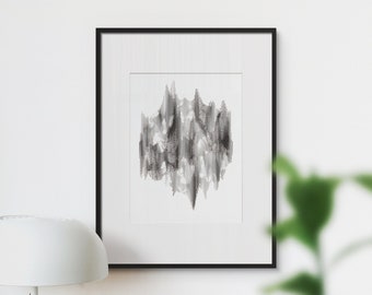 Può includere: Una stampa d'arte astratta in bianco e nero in una cornice nera, appesa a una parete bianca sopra una scrivania con una lampada, una pianta grassa in vaso, un laptop e una pila di libri.