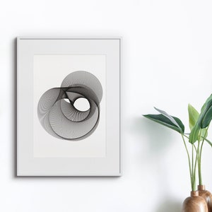 May include: A black and white abstract geometric design print in a white frame. The print features a series of overlapping circles and lines creating a swirling effect.