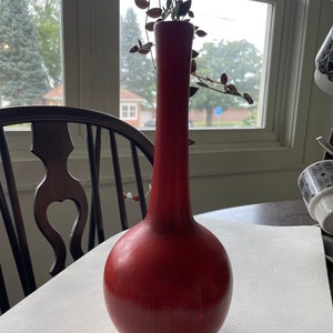 May include: A white ceramic mug with a black handle and the text "But First, Coffee" in a black, bold font. The mug is on a white surface.